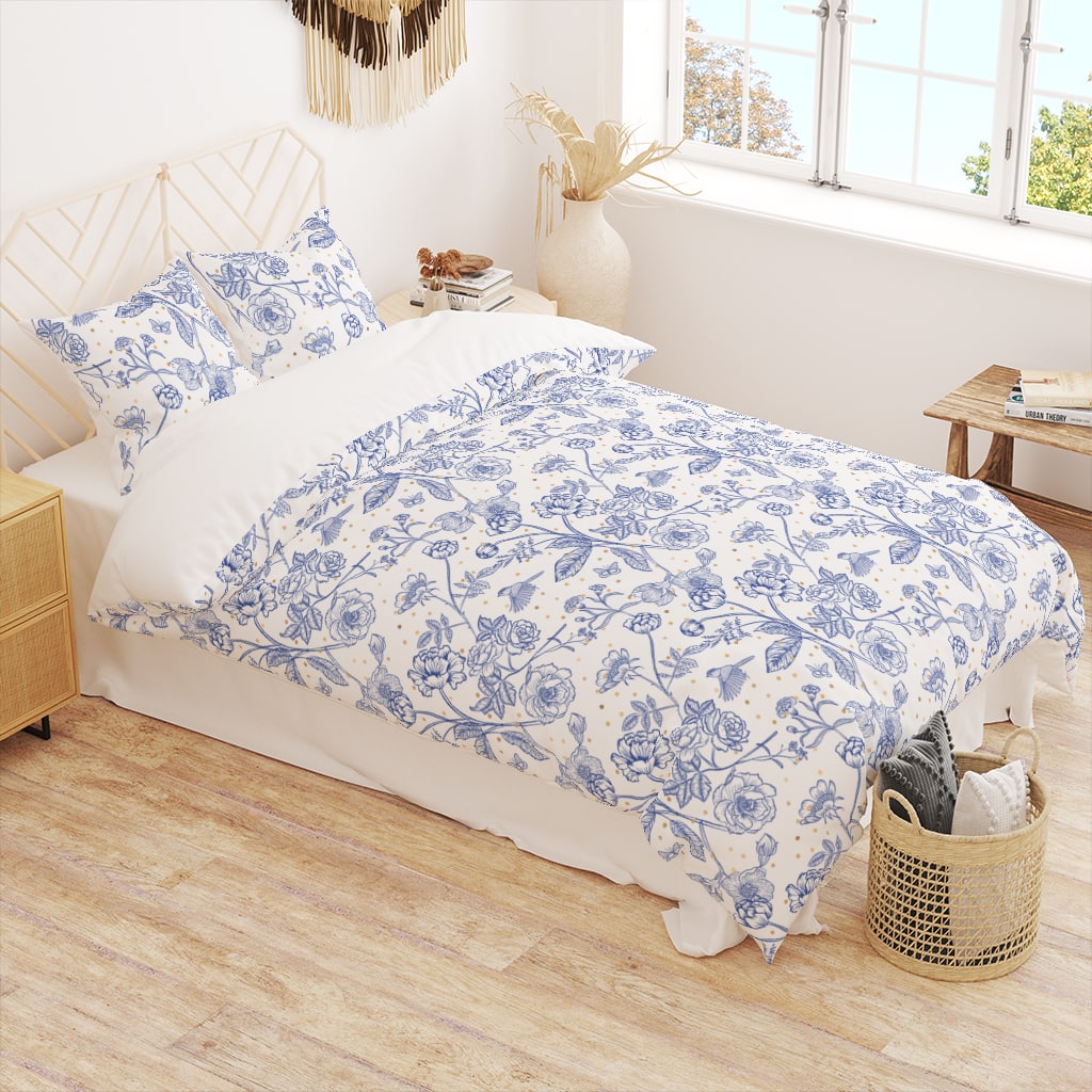 Classic white and blue toile de Jouy bedding set with gold-colored dots.