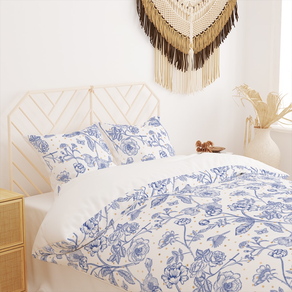 Classic white and blue toile de Jouy bedding set with gold-colored dots.